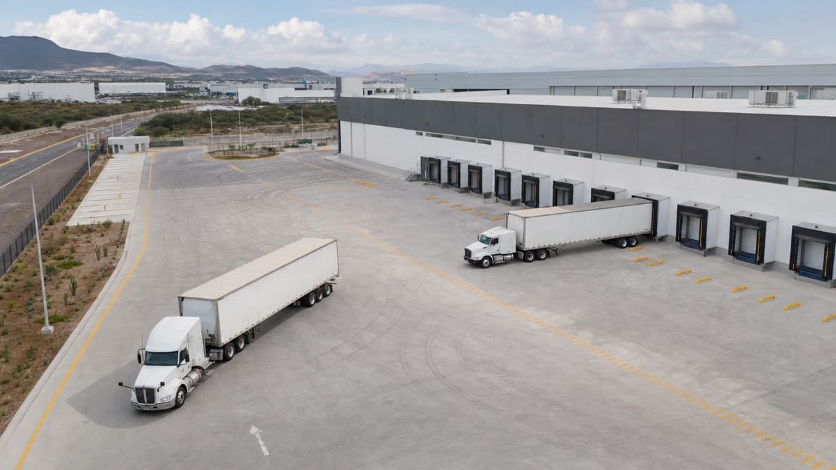 Aerial view of an industrial truck court with loading docks, circulation lanes, and maneuvering tractor-trailers